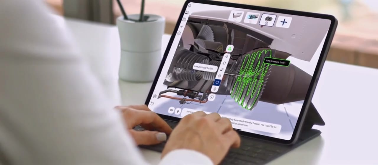 A person edits a Jig of a jet engine on an iPad with a keyboard, adding labels to parts and steps to the sequence